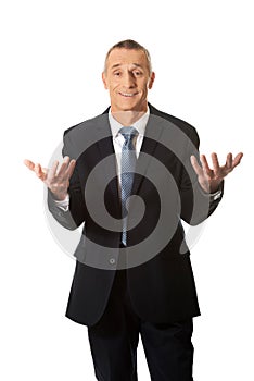 Businessman with open hands in undecided gesture