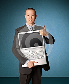 Businessman with open laptop shows welldone photo