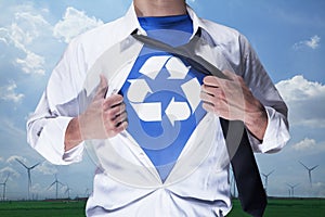 Businessman with open short revealing shirt with recycling symbol underneath photo