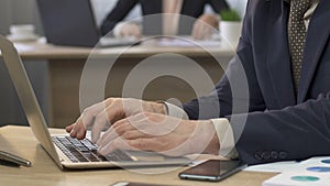 Businessman opening his laptop and answering e-mail, business correspondence