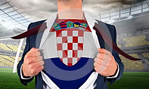 Businessman opening shirt to reveal croatia flag