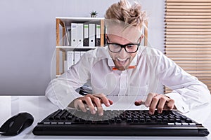 Businessman In Orange Bow Typing On Keyboard