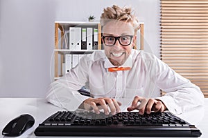 Businessman In Orange Bow Typing On Keyboard