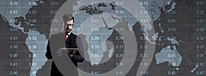 Businessman over dark background. World map background. Business, globalization, capitalism concept.