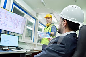 Businessman Overseeing Plant Production photo