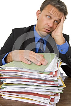 Businessman Overwhelmed By Paperwork