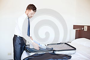 Businessman packing his bags in a hotel