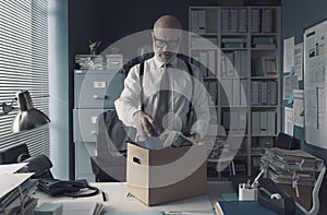 Businessman packing and leaving the office