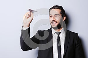 Businessman with paper airplane.