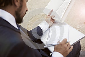 A businessman with paper documents and laptop