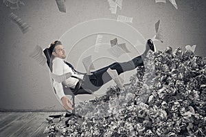 Businessman with paper sheet anywhere. Buried by bureaucracy. Concept of overwork photo