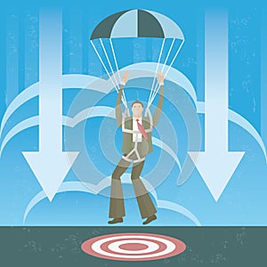 Businessman in parachute landing on the target