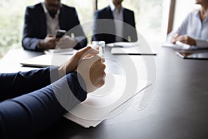 Businessman participates in meeting, put his hands on table closeup