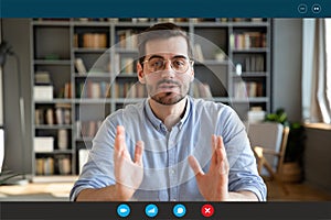 Businessman participates at negotiations by videocall via teleconference, screen view