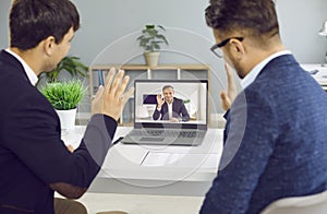 Businessman participates in virtual remote negotiations with colleagues through video call.
