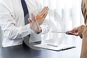 Businessman partner hand gesture rejecting refusing money, anticorruption concept photo