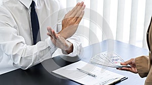 Businessman partner hand gesture rejecting refusing money, anticorruption concept photo