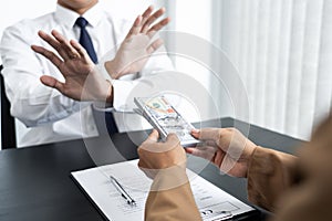 Businessman partner hand gesture rejecting refusing money, anticorruption concept photo