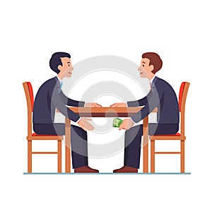 Businessman passing money under table to partner