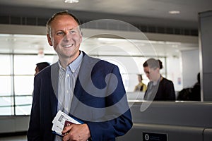 Businessman with passport and boarding pass at the airport