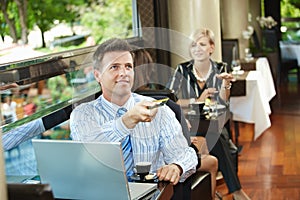 Businessman paying in cafe