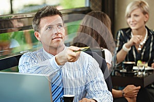 Businessman paying in cafe