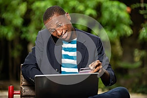 Businessman paying with credit card on laptop