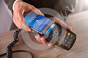 Businessman paying through mobile NFC technology