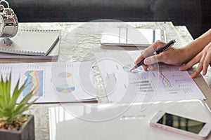 Businessman pen pointing graph chart for analyzing investment,Business analysis and strategy concept,