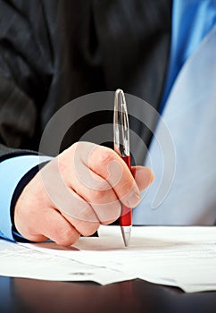 Businessman with pen signing contract