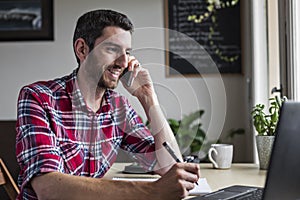Businessman on phone call in home office