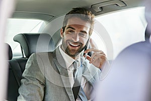 Businessman, phone call and smile in car seat for audio conversation, funny joke or good news in urban city. PR manager