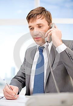 Businessman with phone and documents