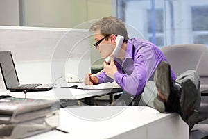 businessman on phone looking at screen - bad sitting posture