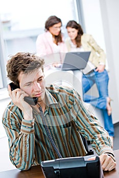 Businessman with phone at office