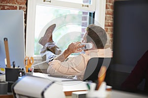 Businessman On Phone Relaxing In Modern Creative Office