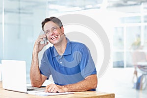 Businessman, phone and smile for conversation in modern office with people, consultation or call for meeting. Male