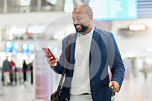 Businessman, phone and smile with luggage for travel, journey or texting in communication at the airport. Happy black