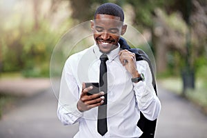 Businessman, phone and typing in city for news online, internet and text message. Male banker, mobile and communication