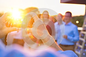 Businessman photographing colleagues during rooftop success party