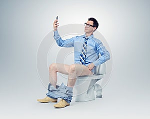 Businessman photographing himself in the toilet