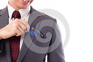 Businessman pick credit card from suit pocket for paying, buying, shopping product with smiley face, happiness. Handsome young