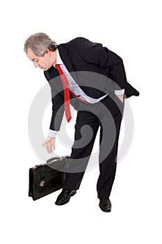 Businessman picking his briefcase