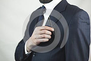 Businessman picking a pen from the pocket