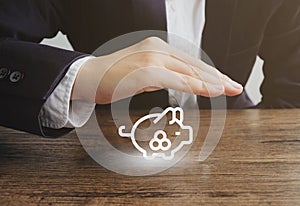 Businessman with the piggy bank icon.Protection saving money concept