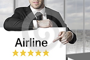 Businessman pilot pointing on sign airline