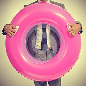 Businessman with a pink swim ring, with a retro effect