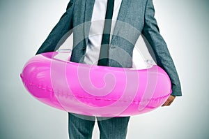 Businessman with a pink swim ring, with a slight vignette added