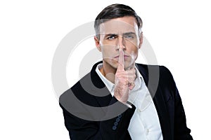 Businessman placing finger on lips saying shhh photo