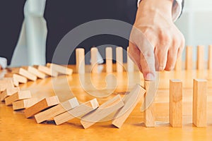 Businessman plan and strategy in business Domino Effect Problem